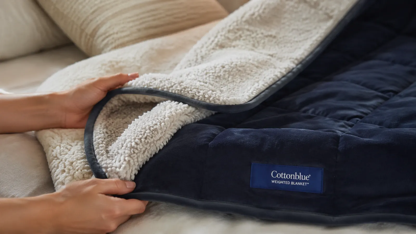 Close-up of the Cottonblue blanket's sherpa texture on one side and smooth microfiber on the other, showing the dual-fabric construction